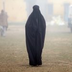 A woman wearing a burka leaves a polling booth after voting during the state assembly election, in the town of Deoband, in the state of Uttar Pradesh